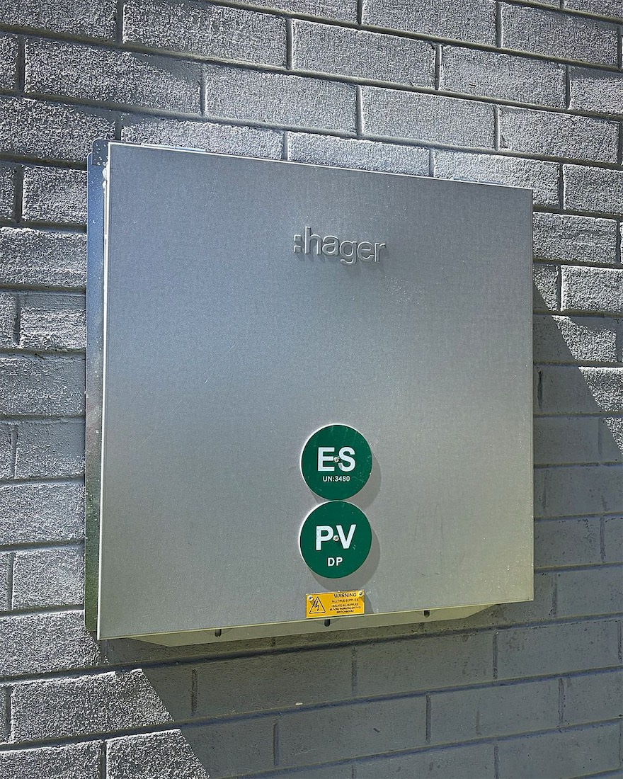New Hager meter box with ES and PV labels on a grey brick wall