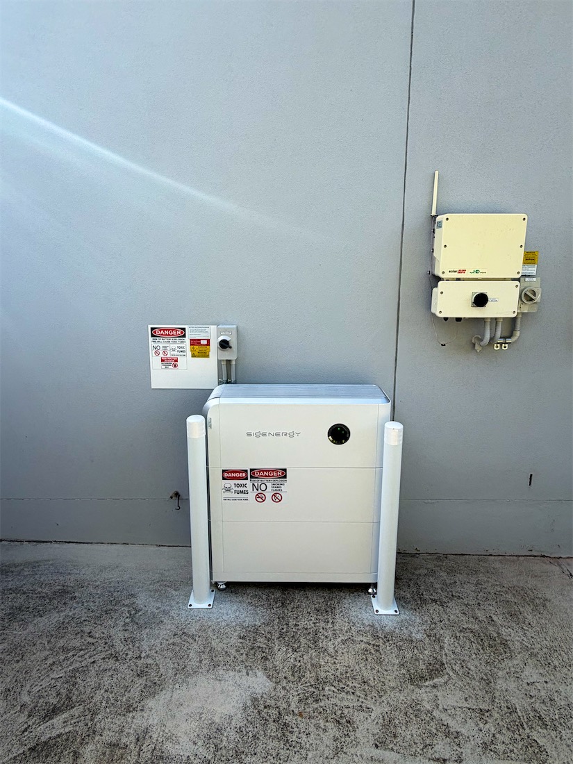 Sigenergy battery with bollards in a driveway in Fisher